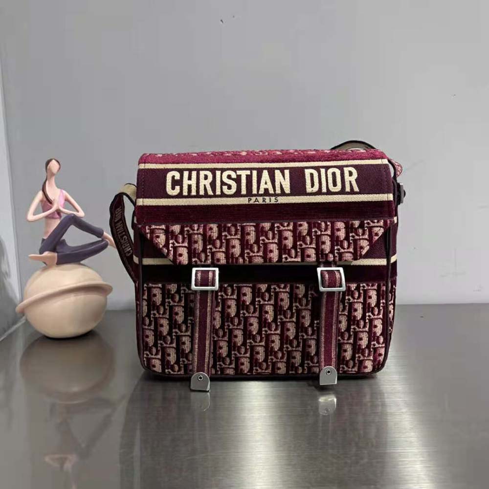 Close-up of maroon canvas with Dior Oblique embroidery detail