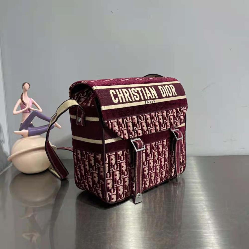Side angle showing silver hardware and zip closure on Diorcamp Bag