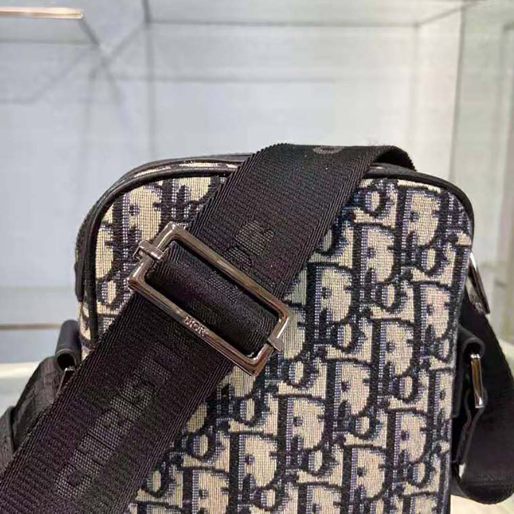 Side angle showcasing flap closure and matte black hardware on Dior Men Messenger Pouch