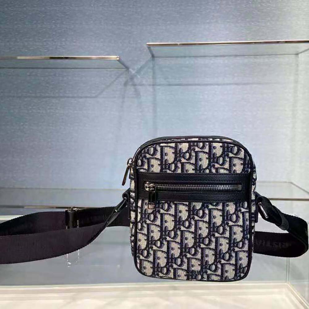 Close-up of Dior Oblique jacquard fabric pattern on messenger pouch