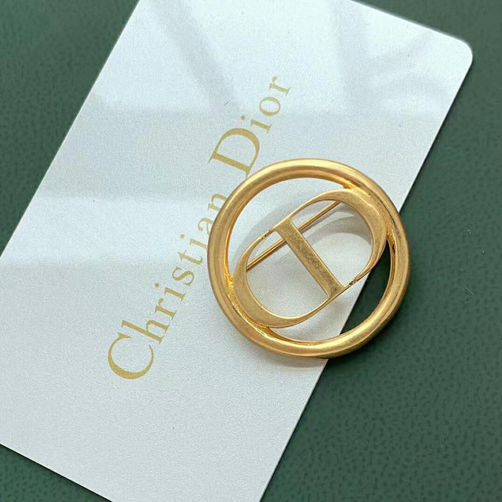 Angled shot highlighting Dior Women 30 Montaigne Brooc Gold-Finish Metal shine