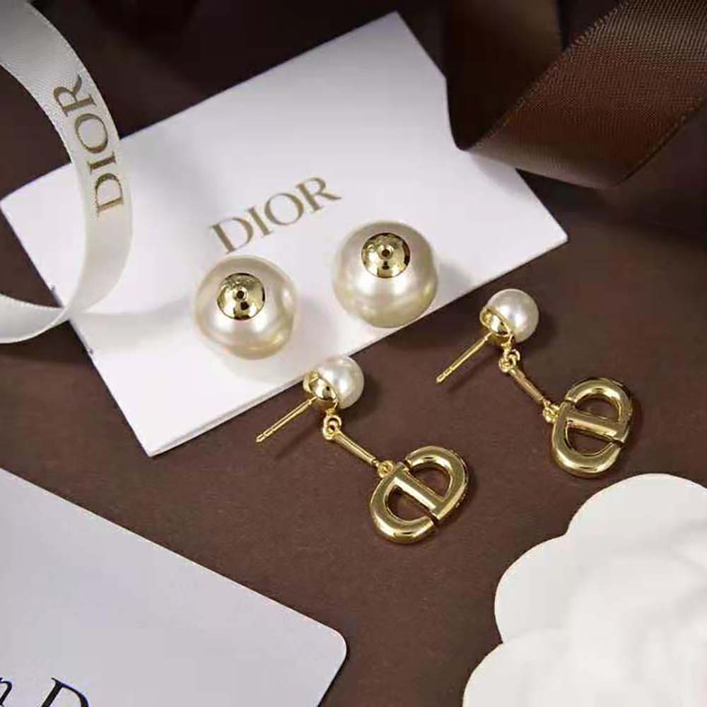 Side view showing silhouette and gold push-back closure of Dior earrings