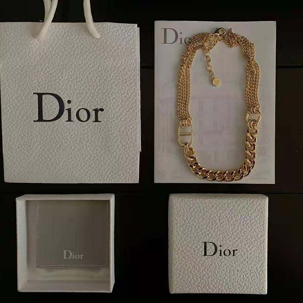 Side angle showing gold-finish chain and clasp of Dior necklace