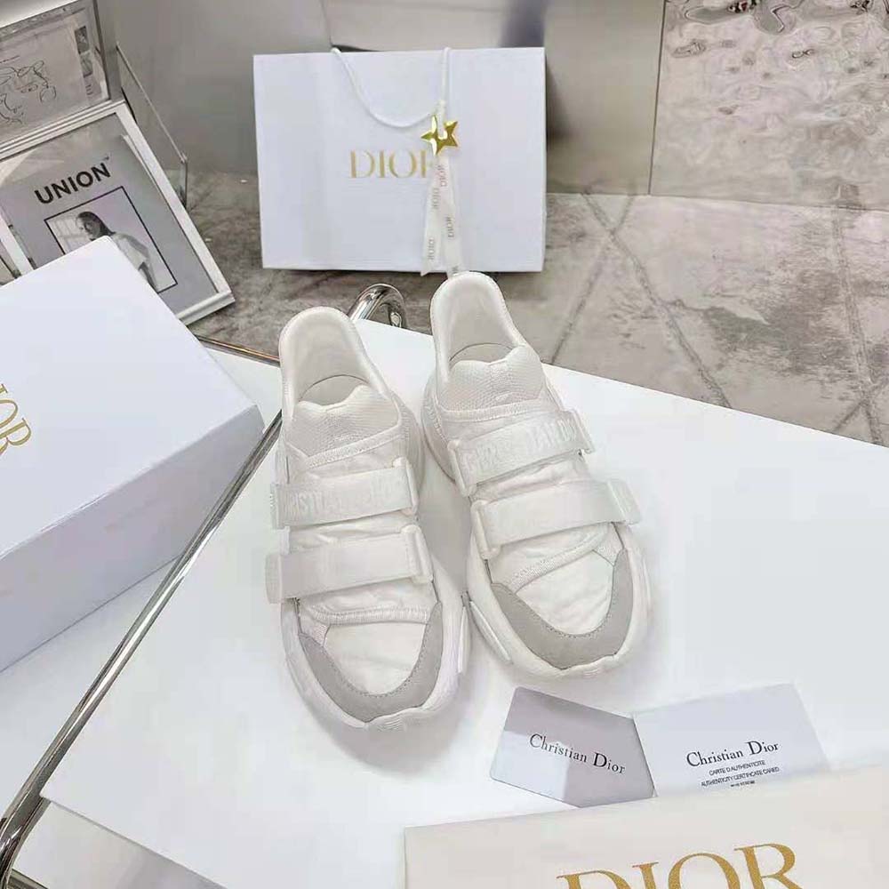 Close-up on Dior sneaker laces and camo fabric texture