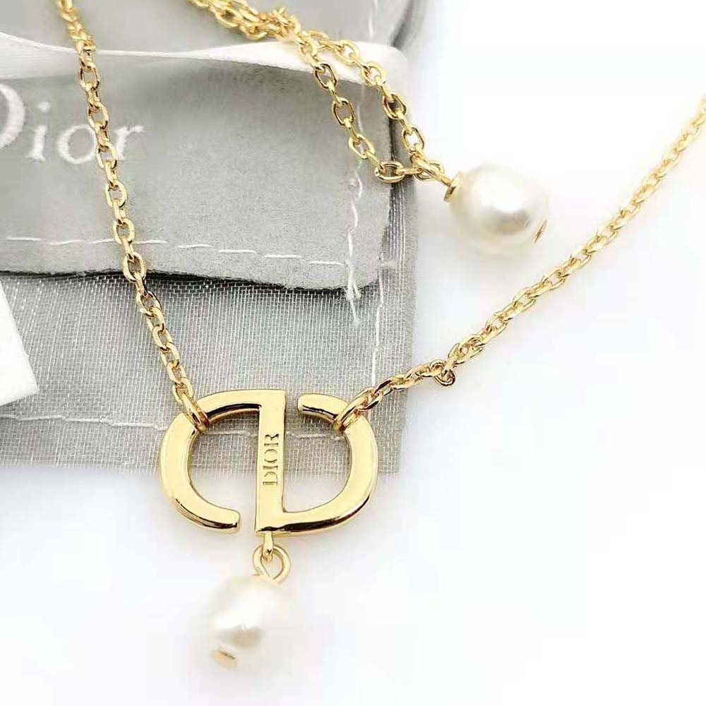 Side angle highlighting gold finish on Dior Women Dior evolution Earrings