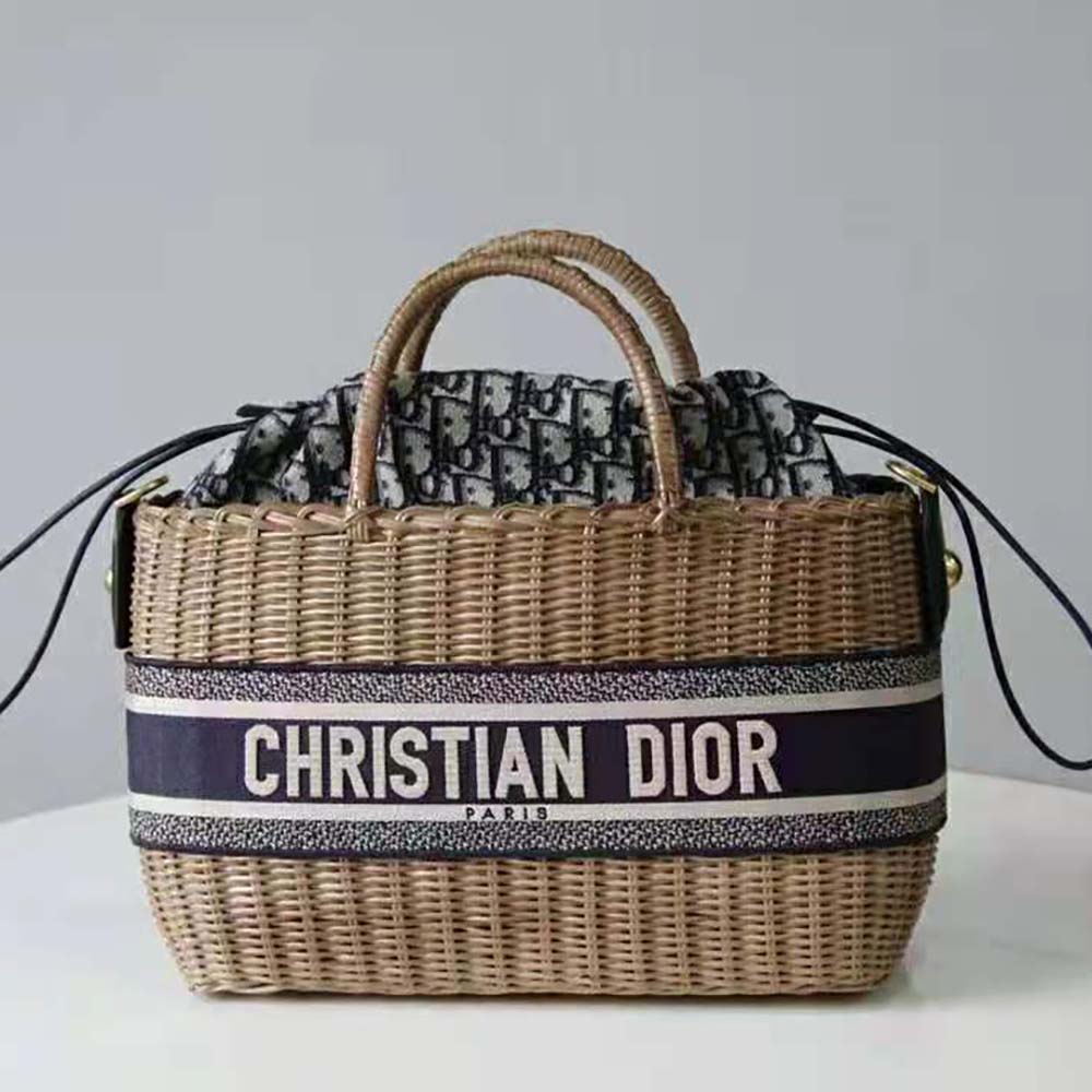 Close-up of blue Dior Oblique jacquard and natural wicker texture