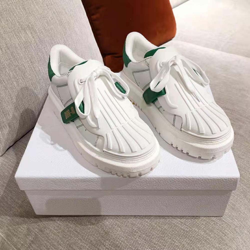 Close-up of green leather detail and Dior-id metal hardware on sneaker