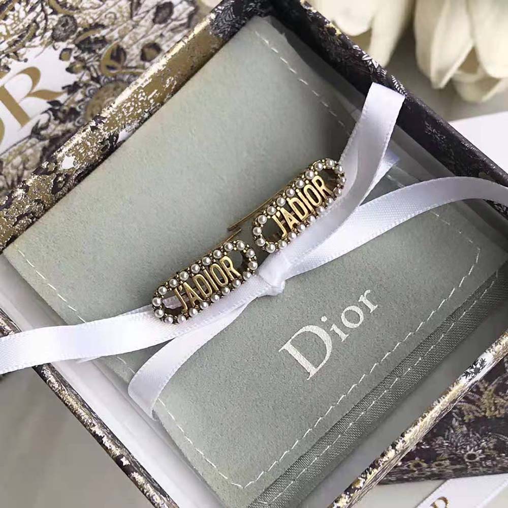 Detailed view of white resin pearls on Dior Women J Adior Earrings