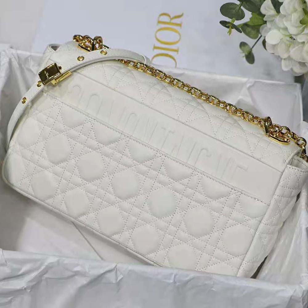 Side angle showing magnetic flap and leather texture of Dior Caro Bag