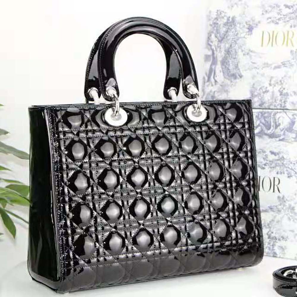 Side angle showing spacious interior and top handle of Lady Dior patent bag