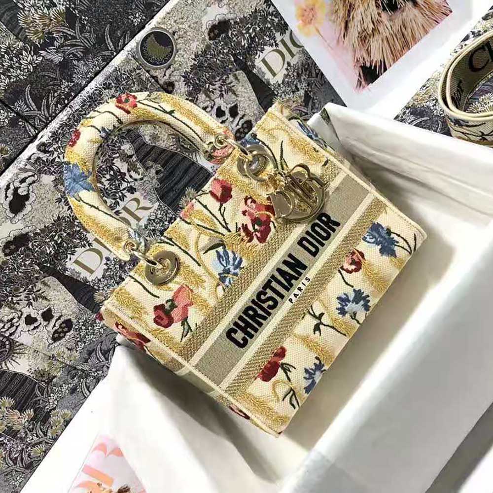 Close-up of metallic hibiscus embroidery on beige Dior Lady D-lite Bag