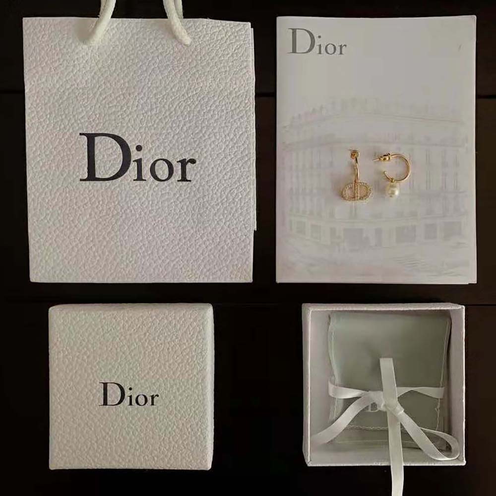 Side angle showing gold-tone metal and pearl detail of Dior Women Petit CD Earrings