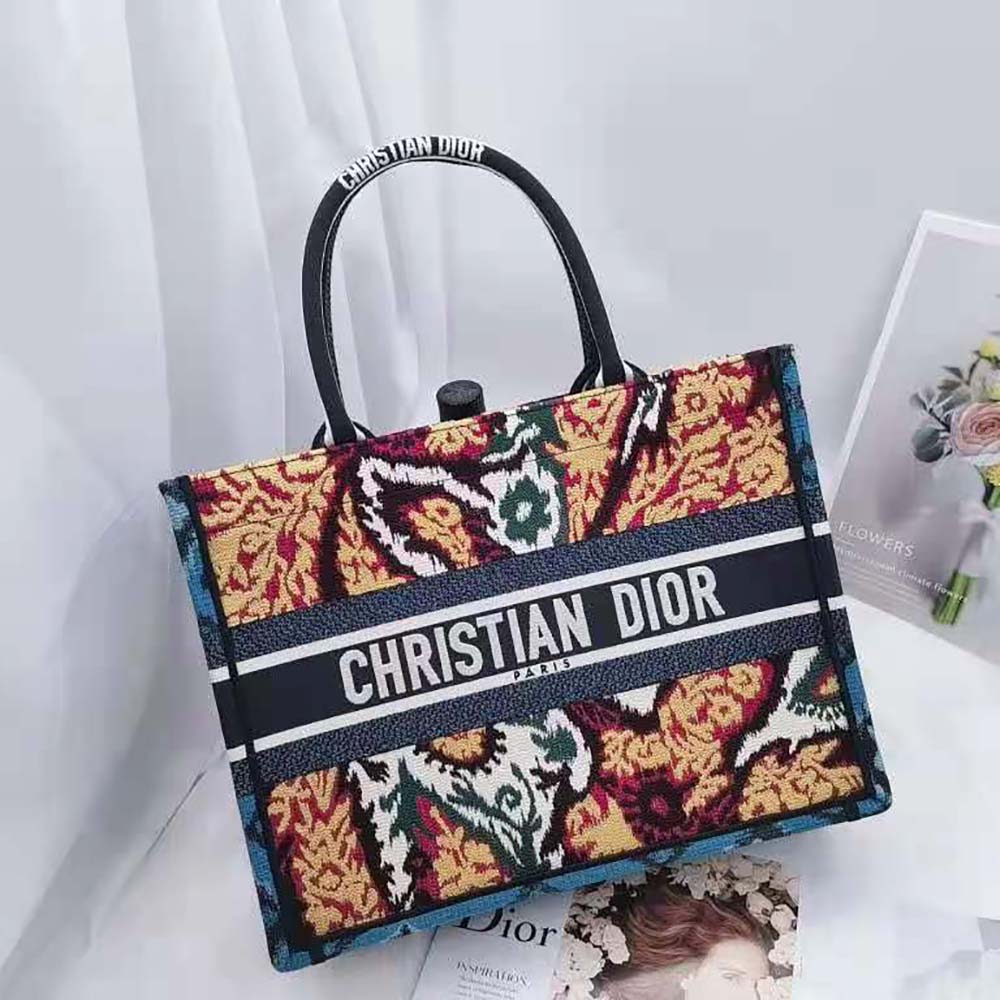 Side angle showcasing silver hardware and zip closure on Dior Small Book Tote