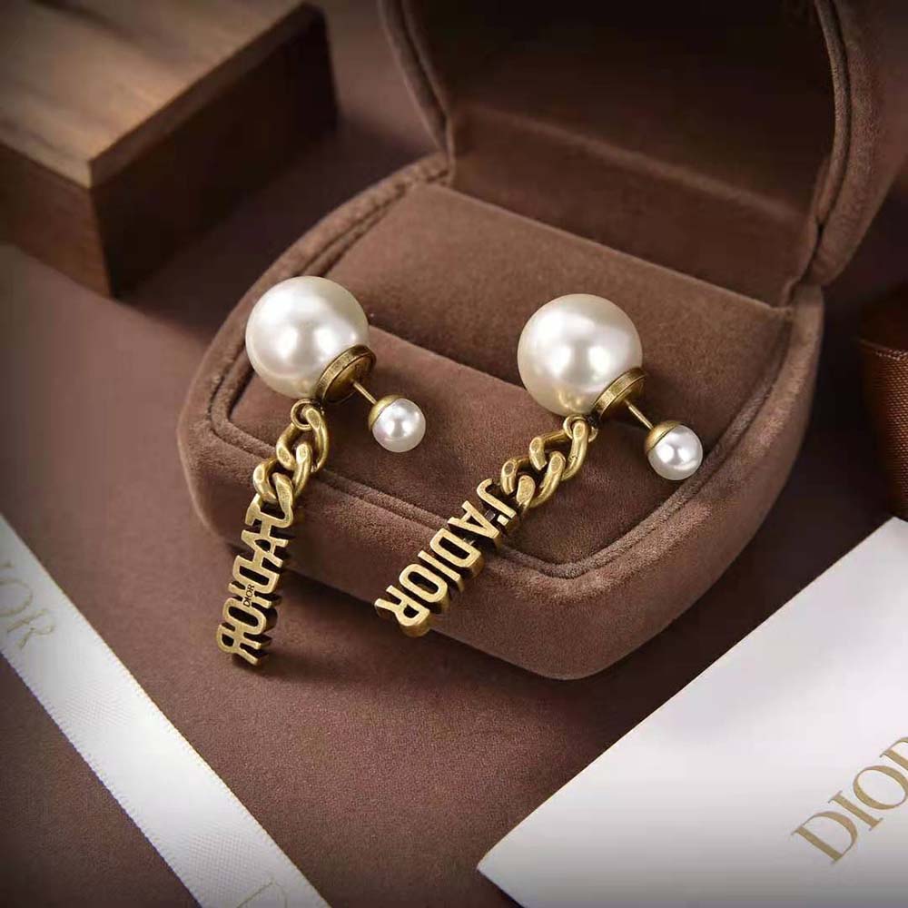 Close-up of pearl detail on Dior Women Tribales Earrings with antique gold finish
