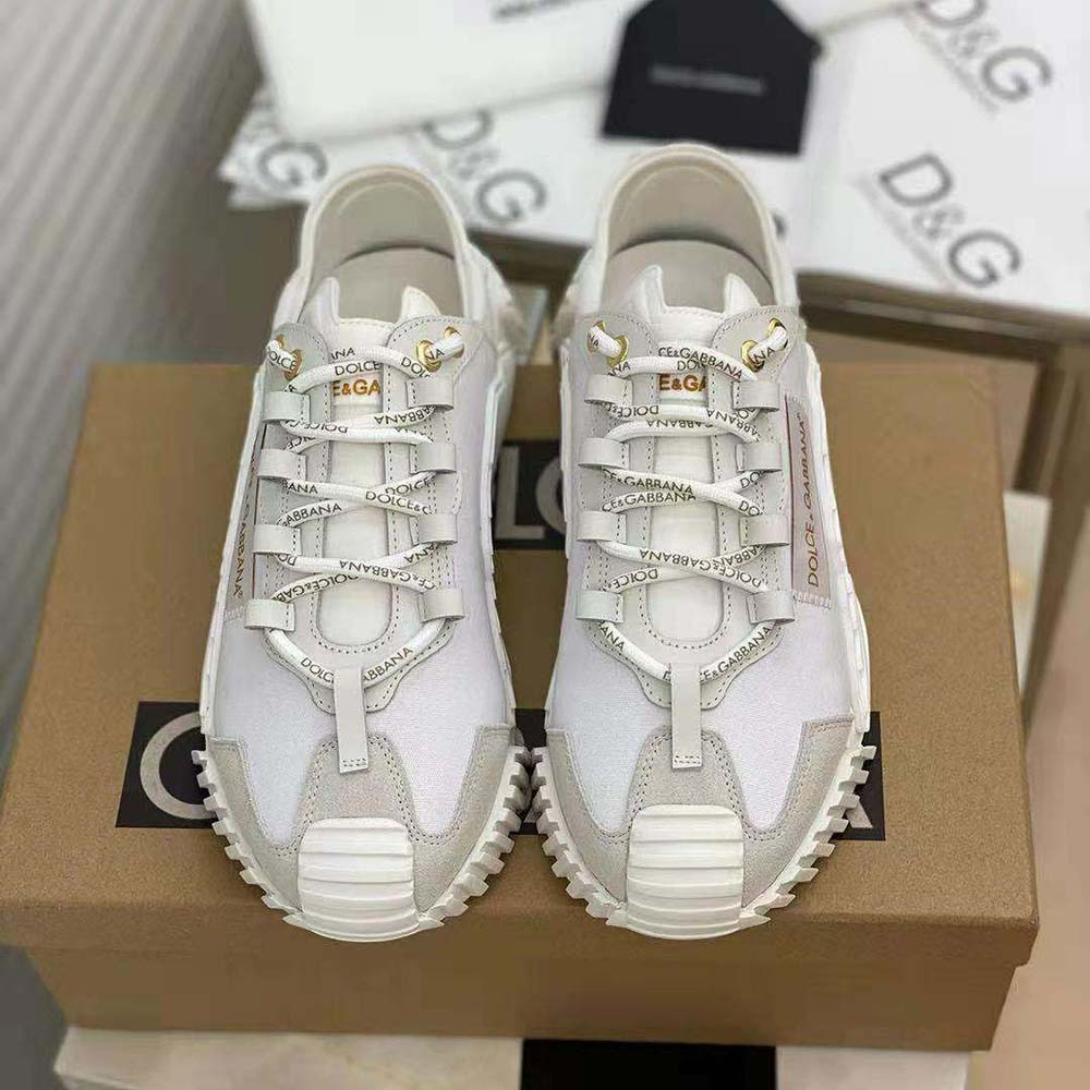 Close-up of white canvas and D&G logo on slip-on sneakers