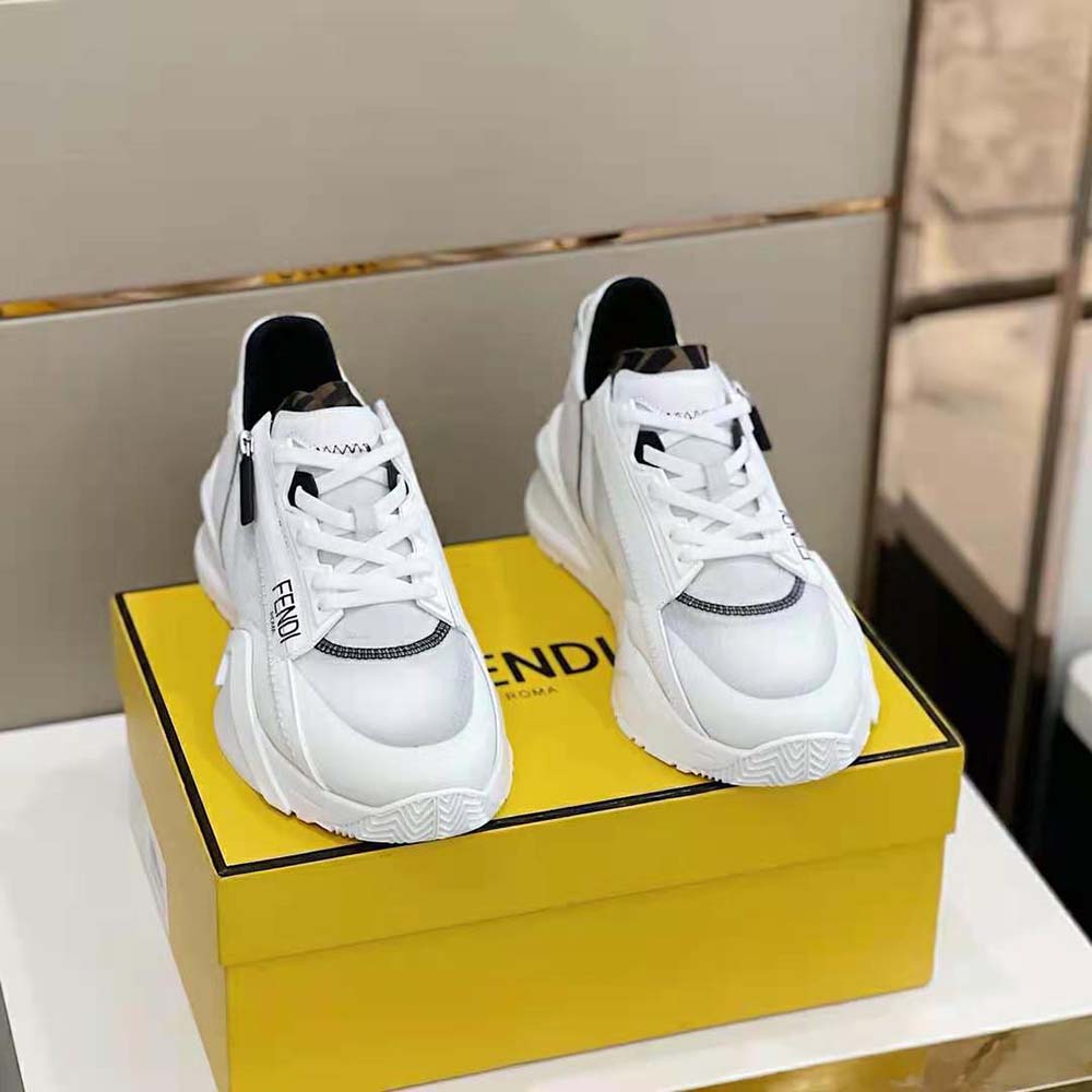 Close-up of Fendi logo hardware on white nylon sneaker