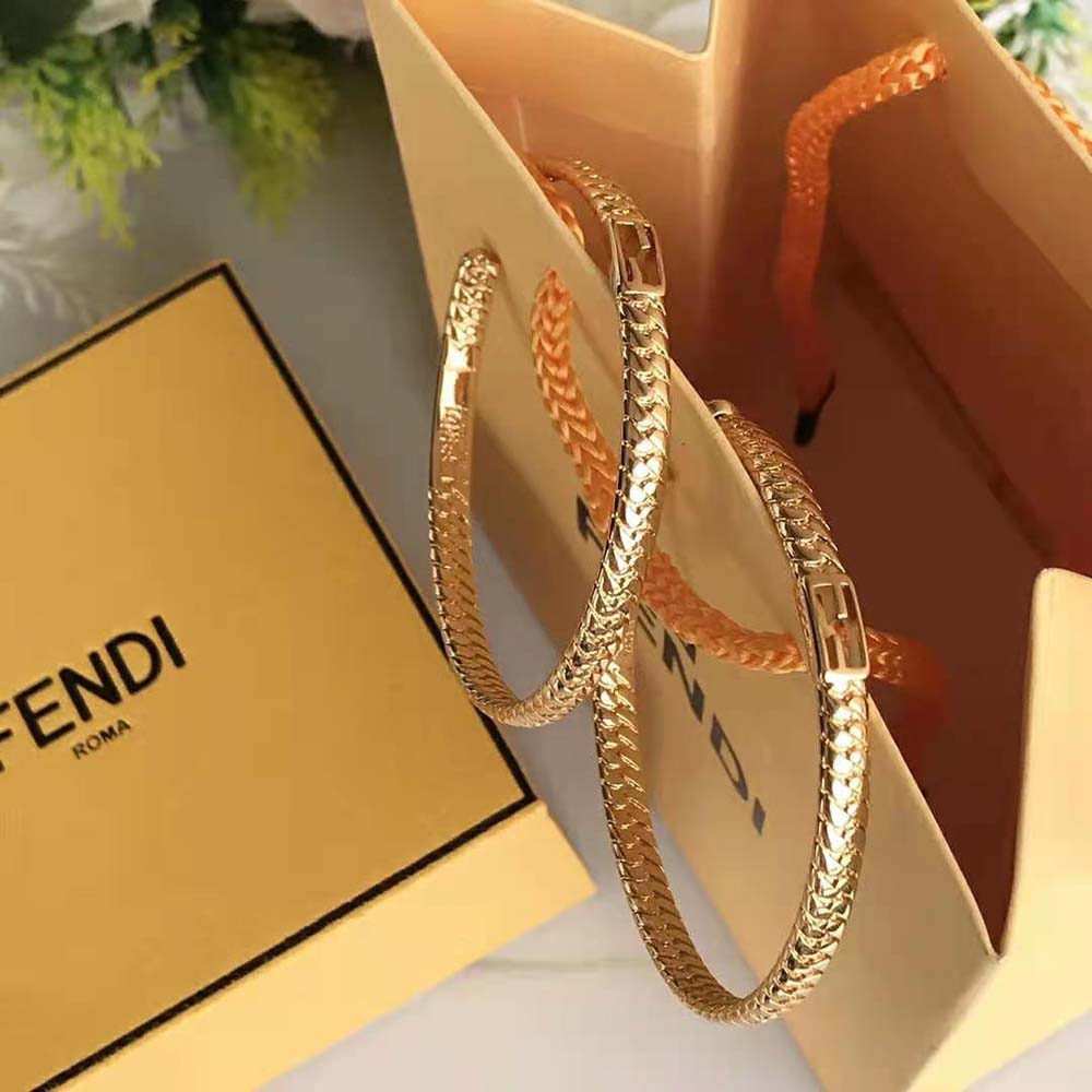 Side angle showing polished finish of Fendi Women Baguette Large Earrings