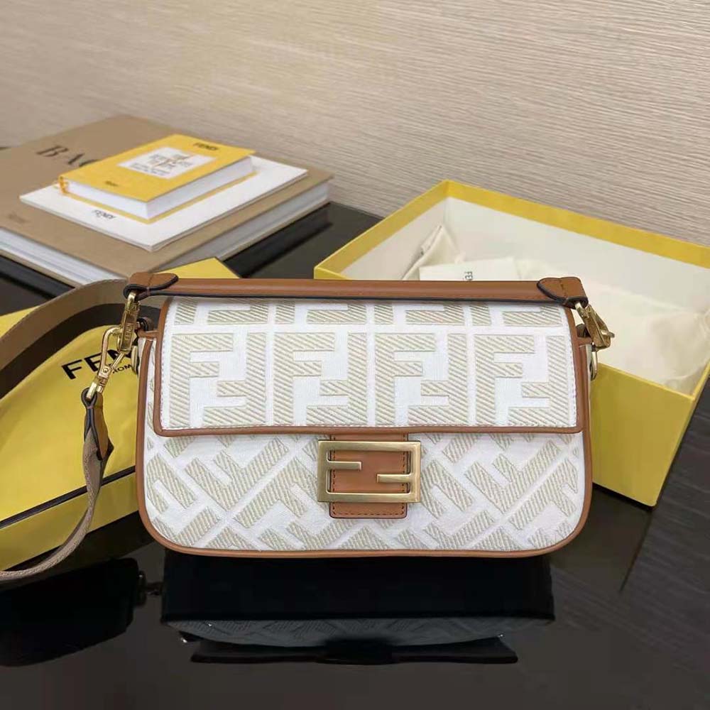 Close-up of Fendi FF monogram on white canvas shoulder bag