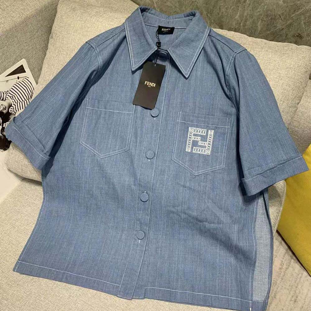 Close-up of signature Fendi logo buttons on chambray chirt