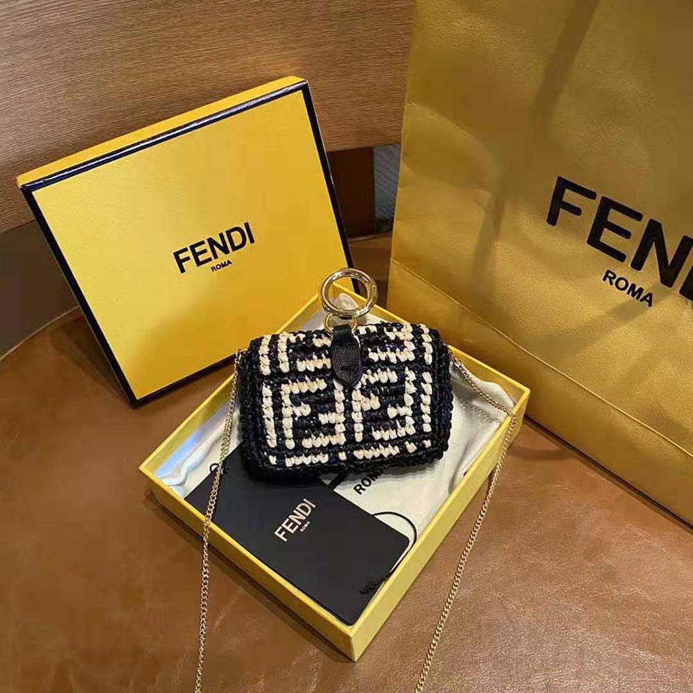Close-up of gold hardware on Fendi Women Nano Baguette Charm Black Raffia Charm
