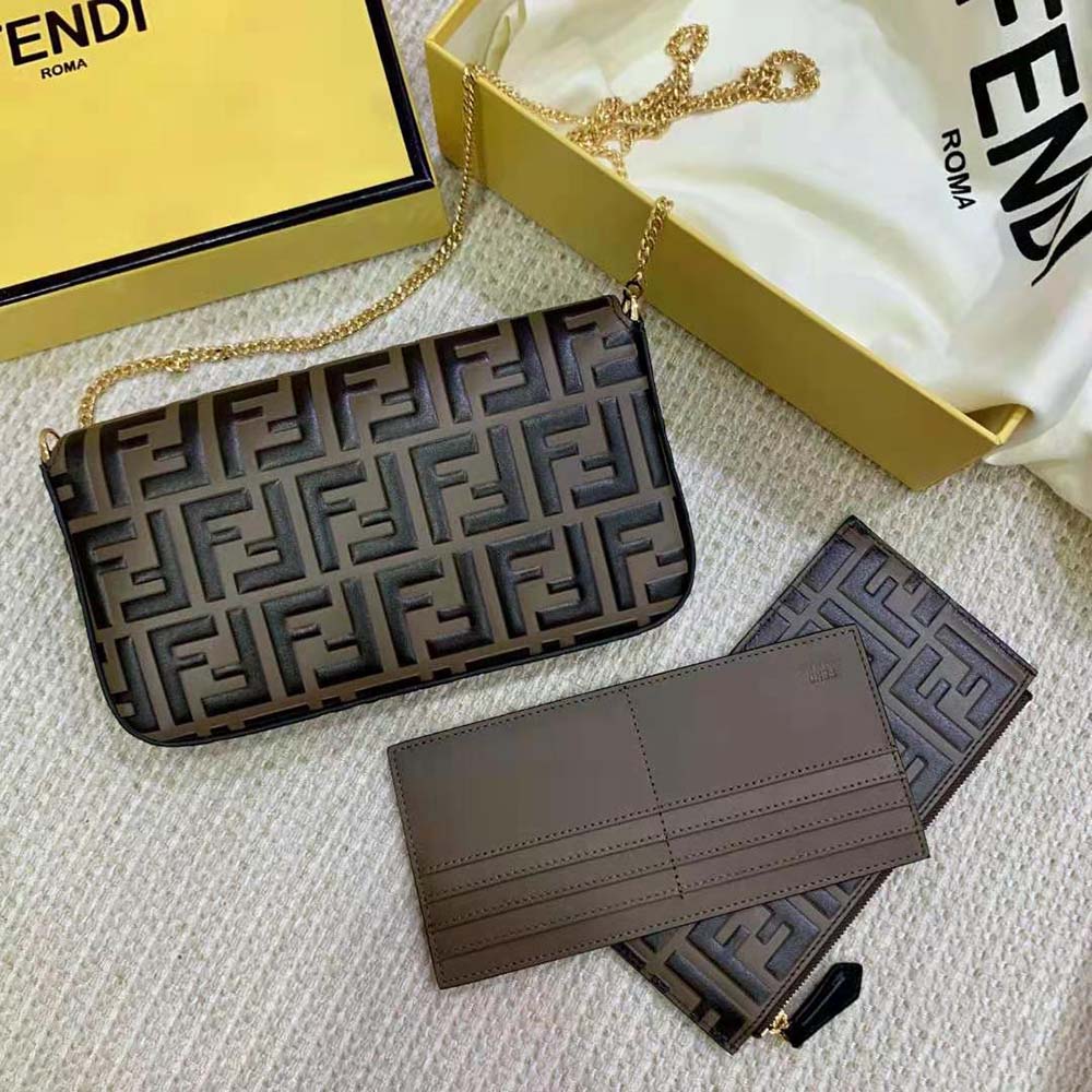 Side angle showing chain strap and compact design of Fendi brown mini-bag