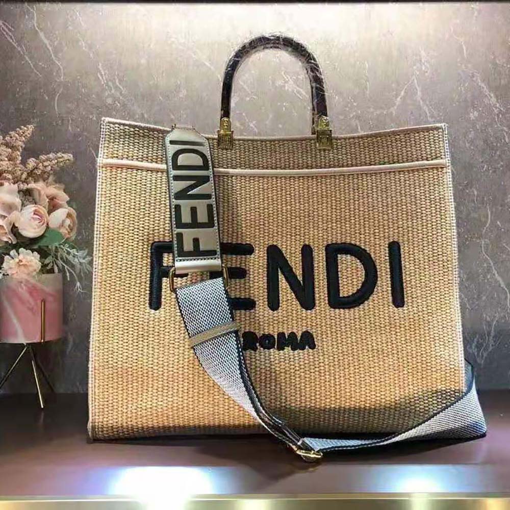 Close-up of woven straw texture and gold hardware on Fendi wallet