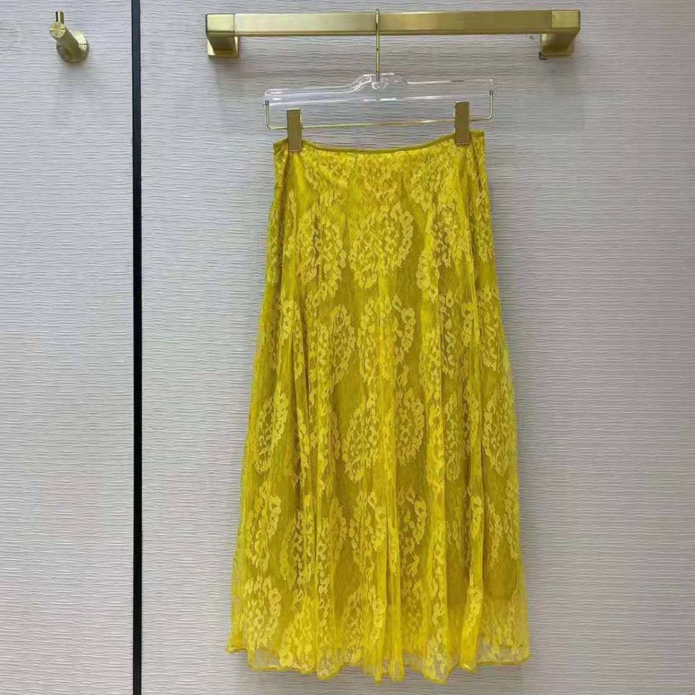 Close-up of lace detail and ABC of Femininity embroidery on skirt