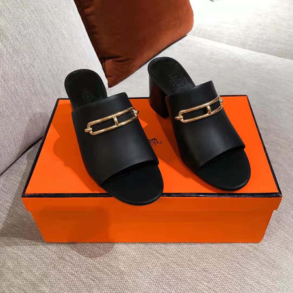 Close-up on black calfskin leather and signature detail of Hermes mule