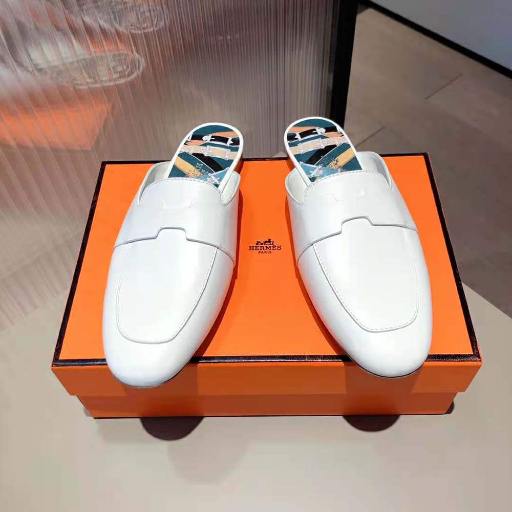 Top-down angle showing open mule silhouette and white goatskin texture