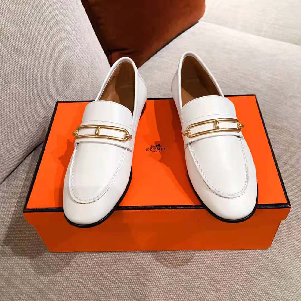 Close-up of white calfskin leather and Hermes tassel detail on loafer