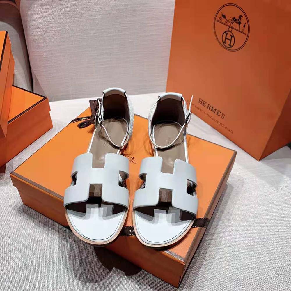 Close-up of Hermes H cutout on white Santorini Sandal