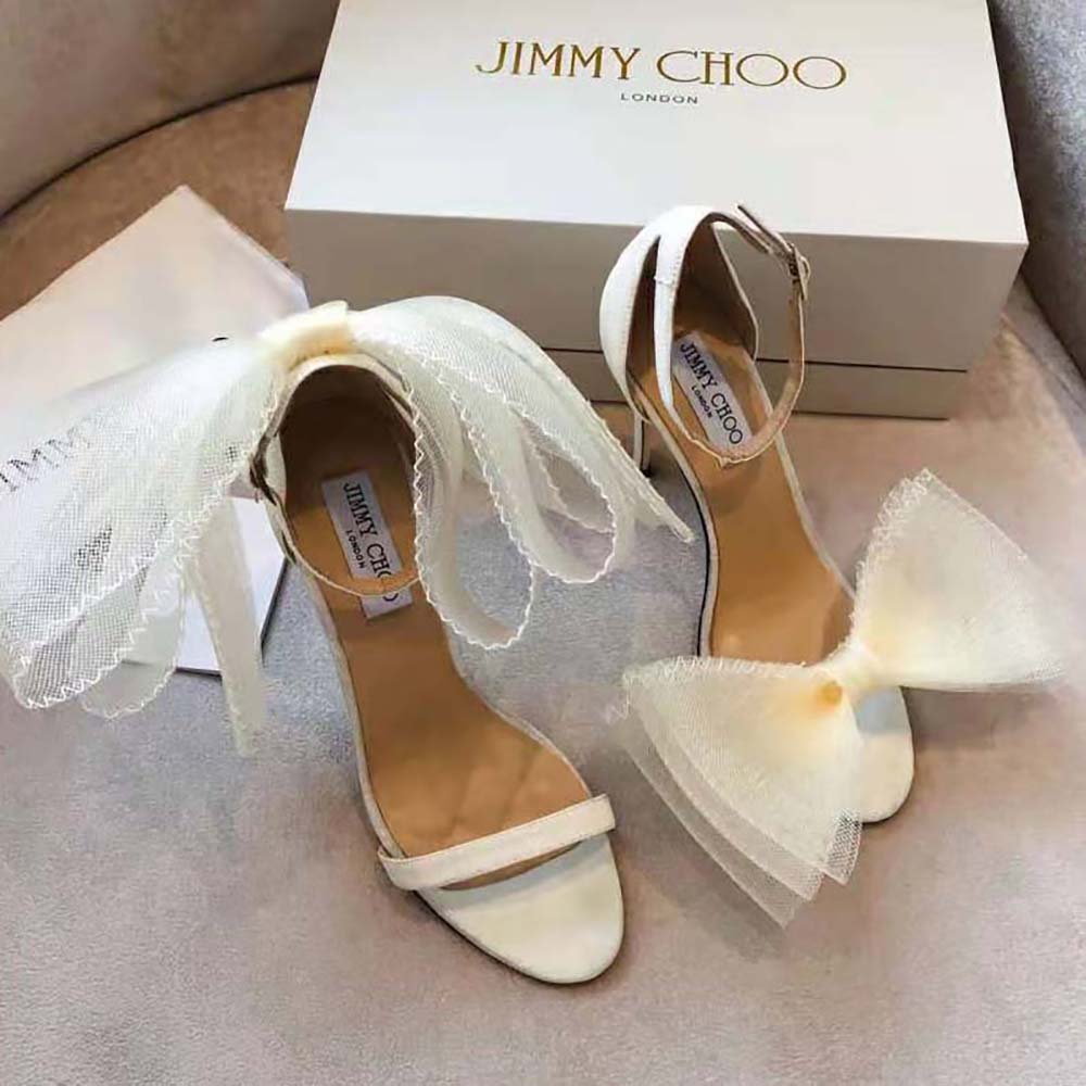Close-up of asymmetric grosgrain mesh fascinator bows on Jimmy Choo sandals