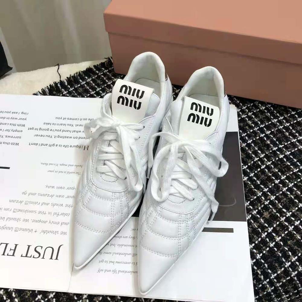 Close-up on laces and nappa leather texture of Miu Miu sneakers