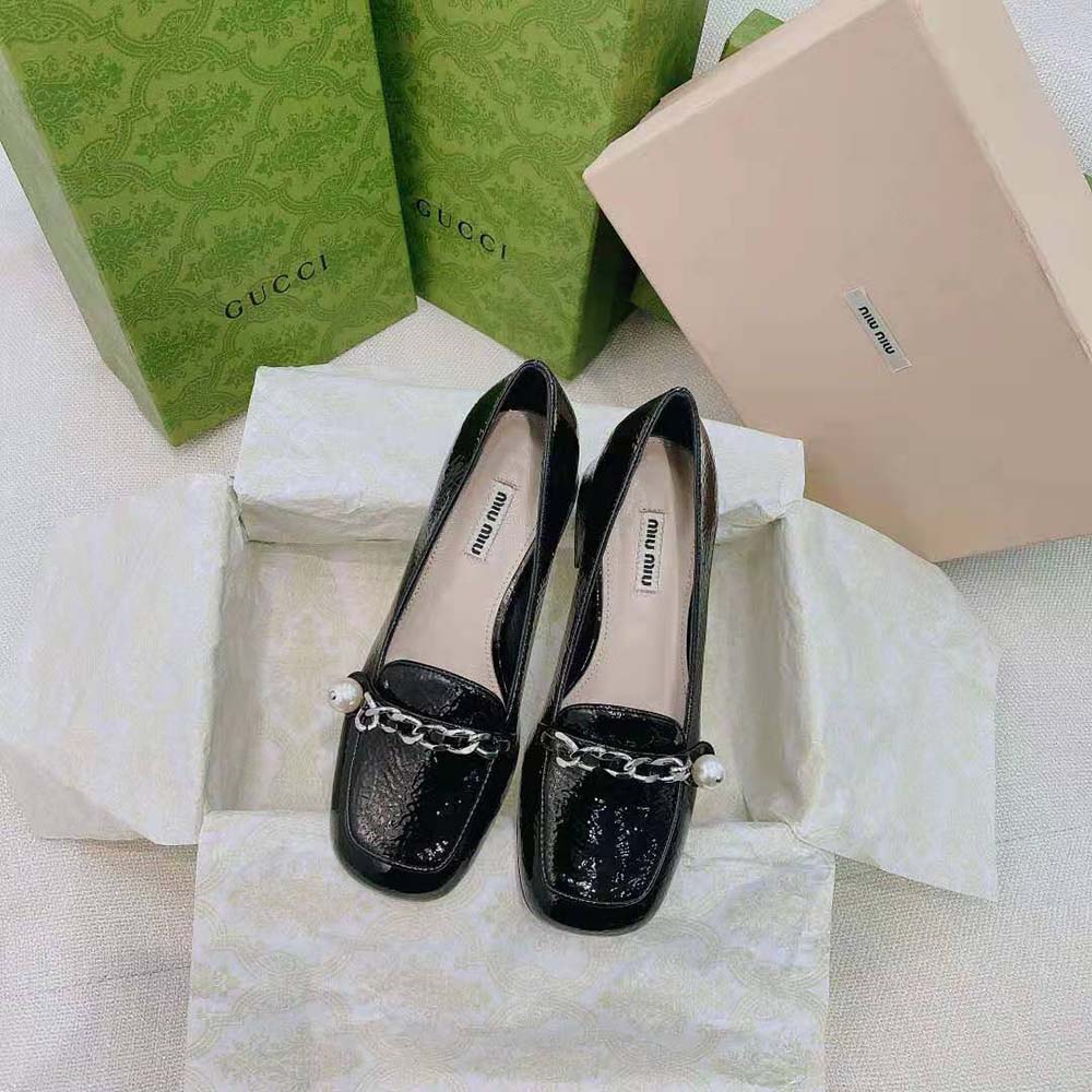 Close-up on silver-tone hardware of Miu Miu Women Patent Leather Loafers