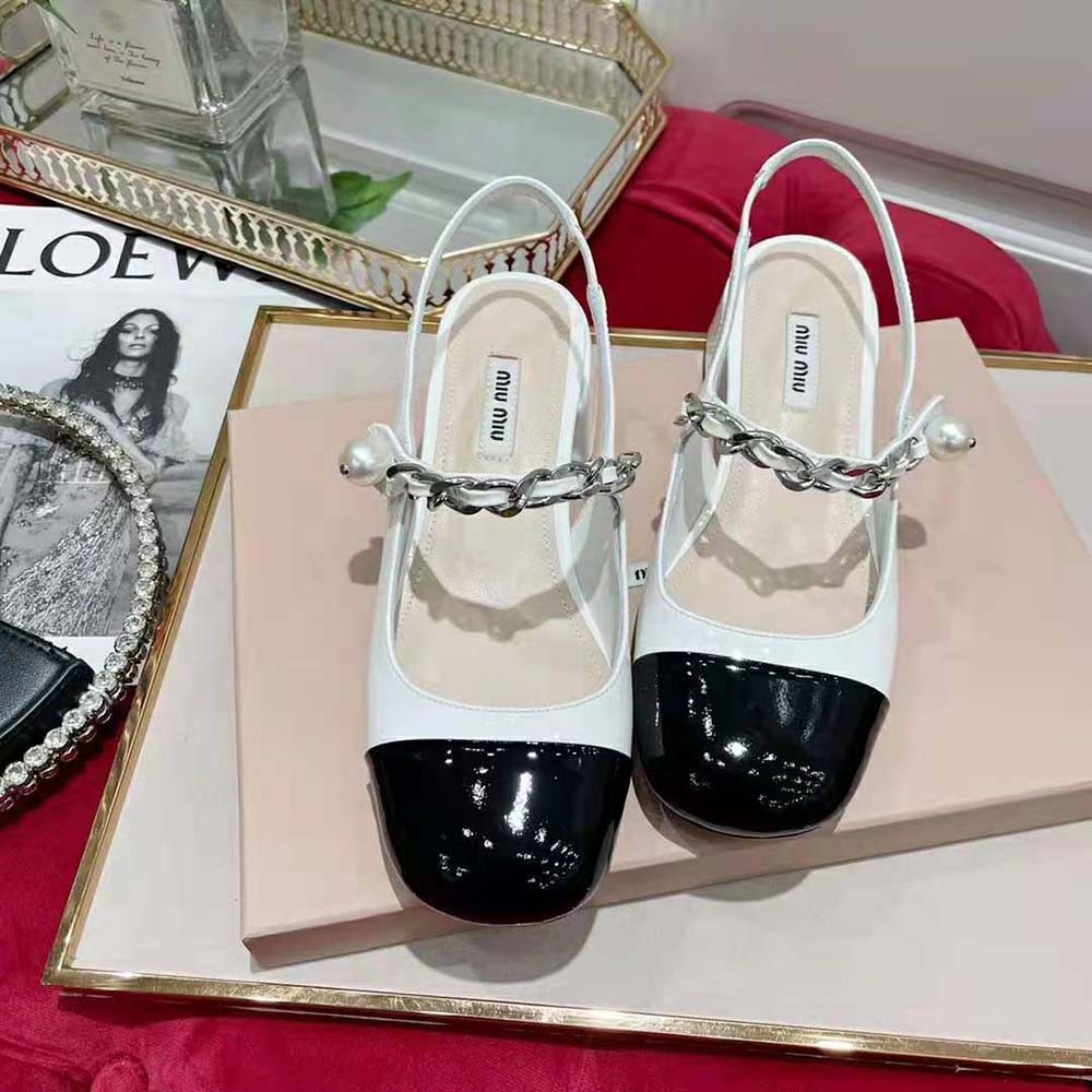 Close-up of glossy patent leather and block heel on Miu Miu pumps