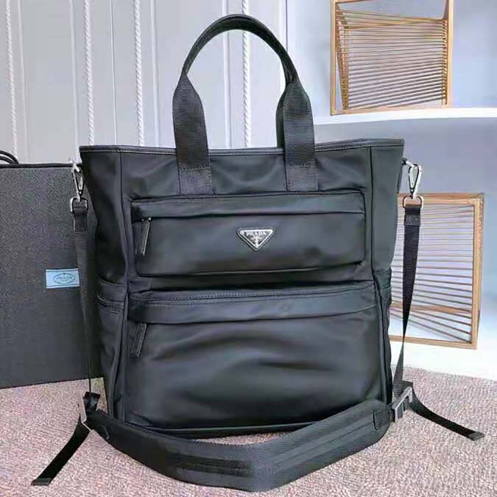Close-up of silver-tone Prada logo on black nylon tote