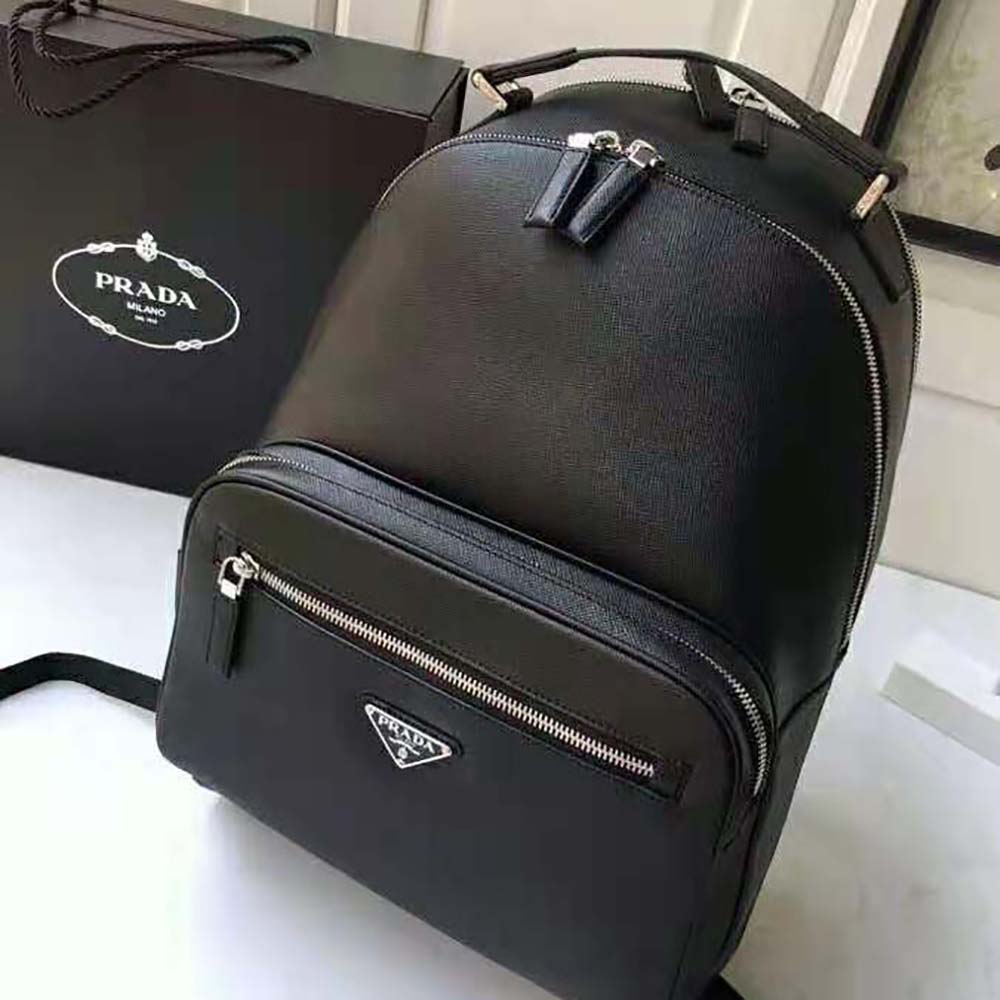 Close-up of Prada logo and silver-tone hardware on backpack