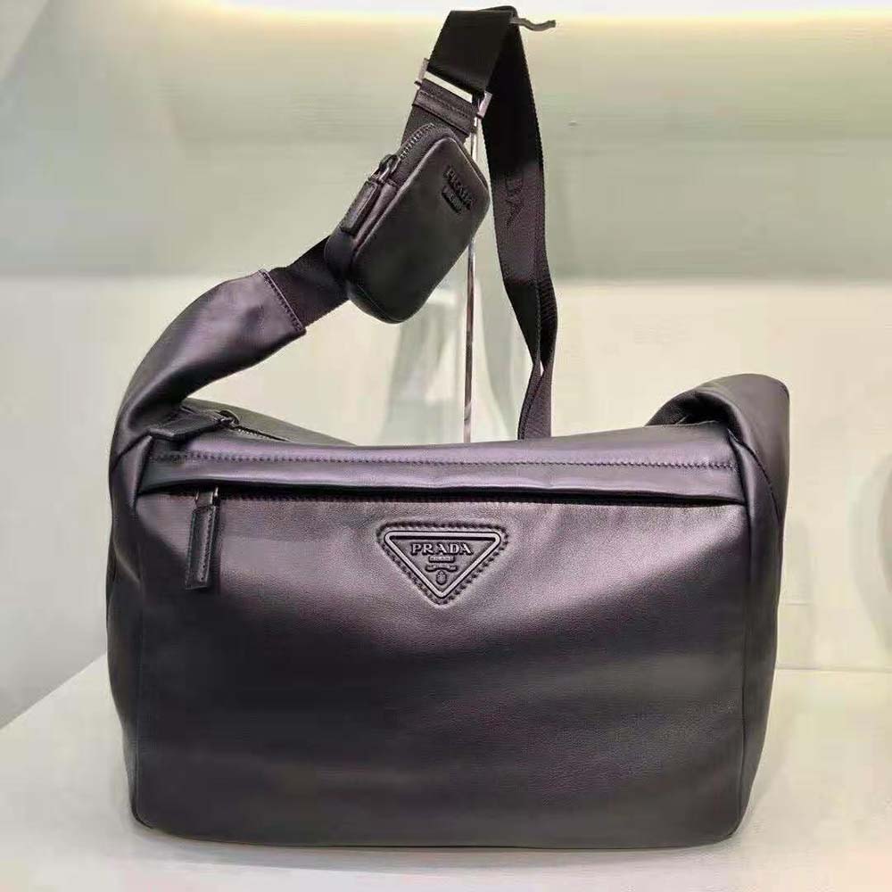 Close-up detail of Prada logo and silver hardware on shoulder bag