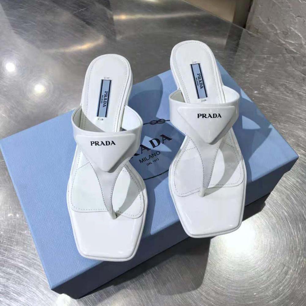Close-up detail of brushed leather and Prada logo on sandal strap