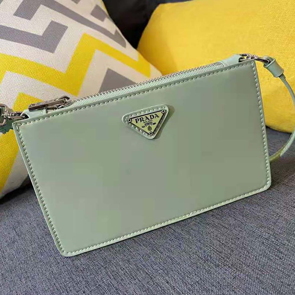 Side angle showing adjustable strap and compact shape of Prada mini-bag