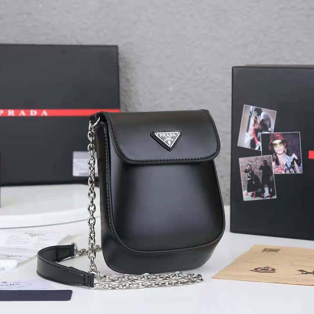 Side angle showing compact silhouette of Prada Women Brushed Leather Mini-bag-Black