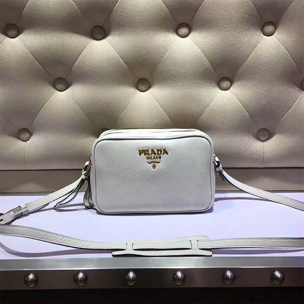 Close-up of silver-tone hardware and white calf leather texture on Prada bag