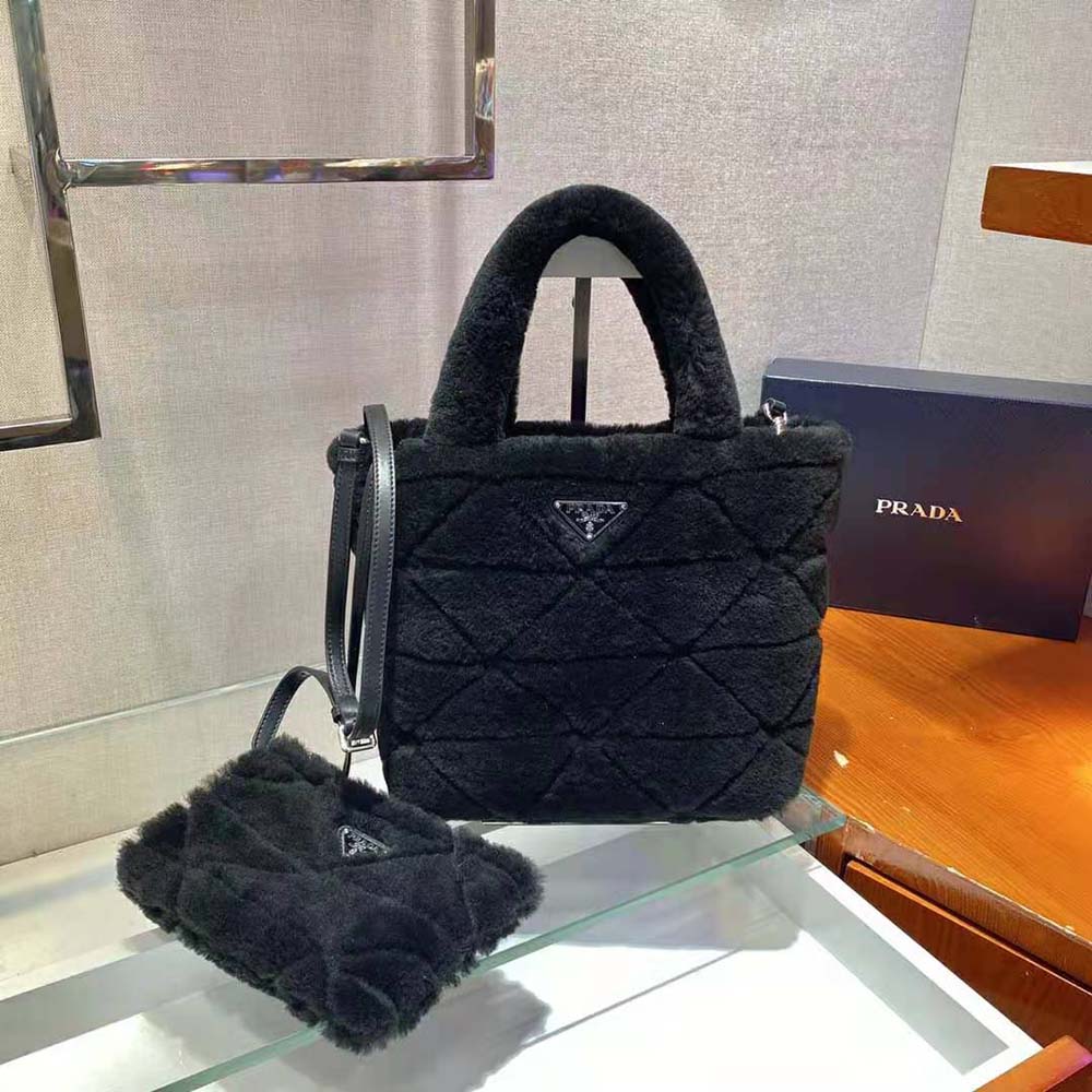 Close-up of the signature triangle logo on Prada shearling tote