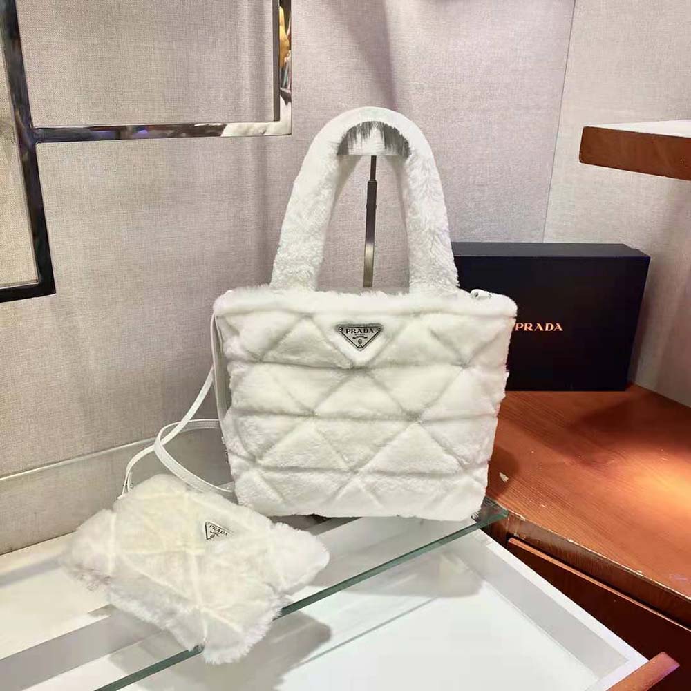 Close-up of Prada triangle logo and white shearling texture on tote