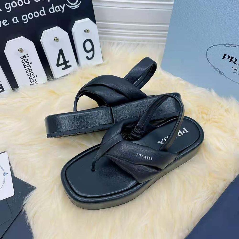 Top-down angle showing thong strap and flatform sole on Prada sandals