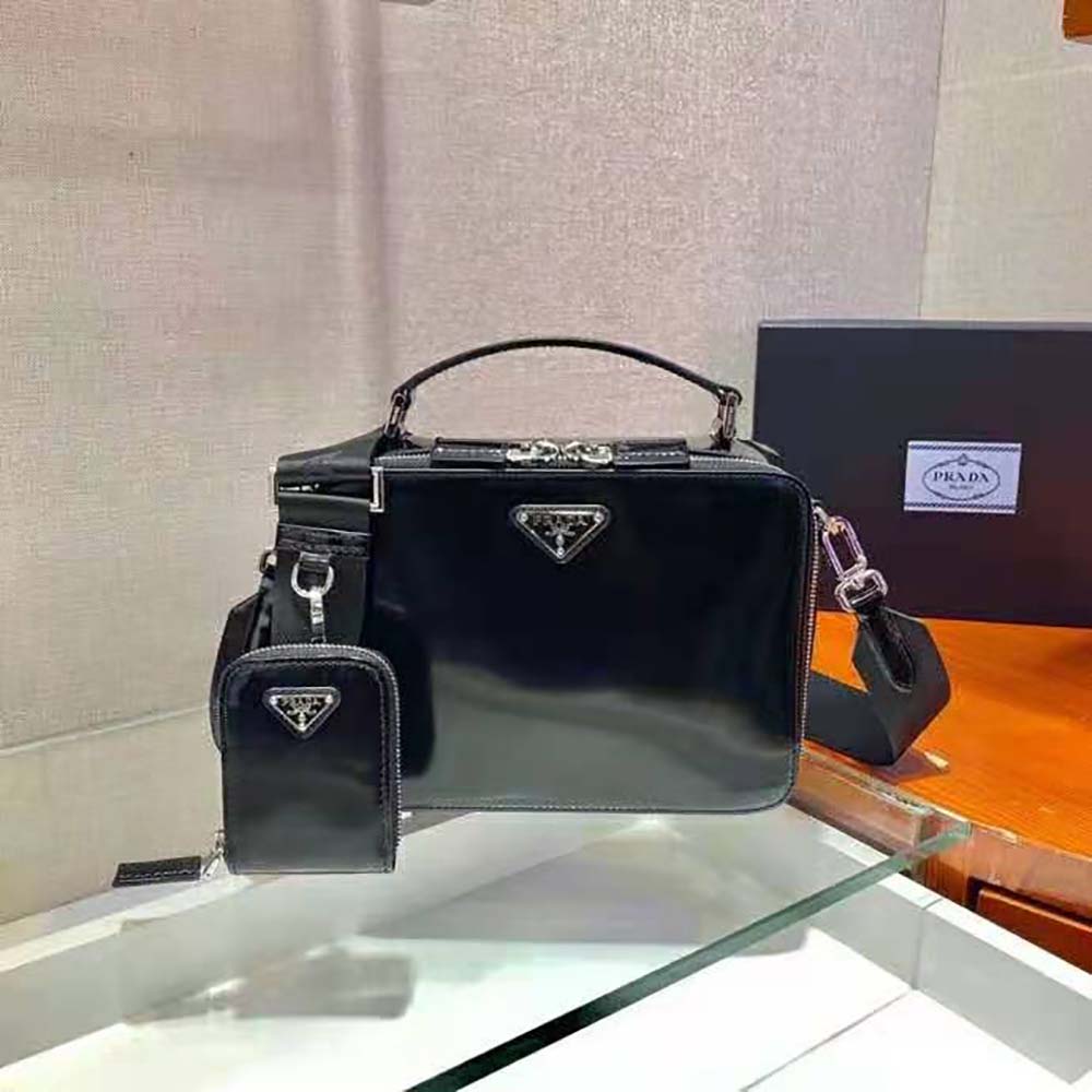 Close-up on silver hardware and brushed leather texture on Prada bag