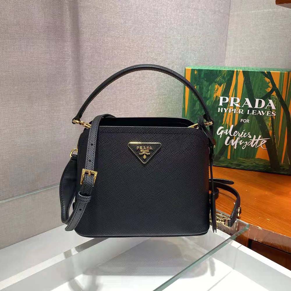 Close-up of Prada triangle logo on the black saffiano leather bag