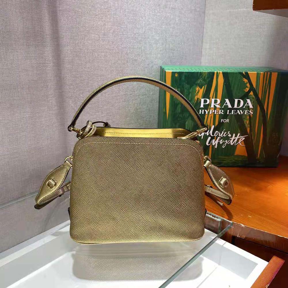 Side angle showcasing the compact shape of Prada Women Prada Matinee Micro Saffiano Leather Bag-Gold