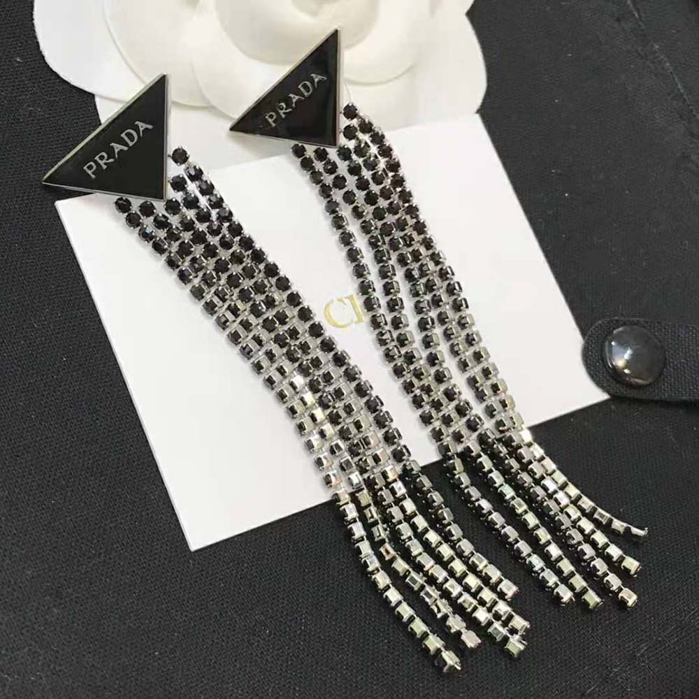 Styled image of Prada Women Prada Symbole Drop Earrings-Black worn by model