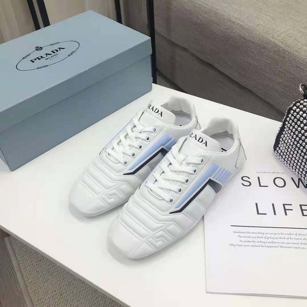 Overhead shot highlighting white leather texture and lace-up closure sneakers